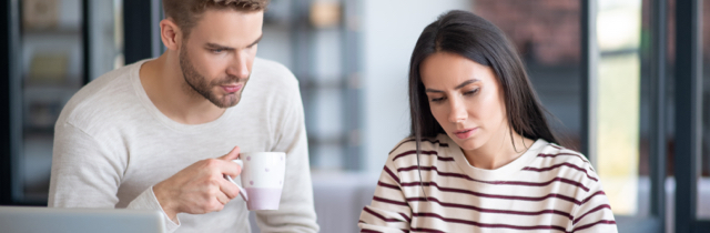 Young couple paying bills to rebuild credit after bankruptcy